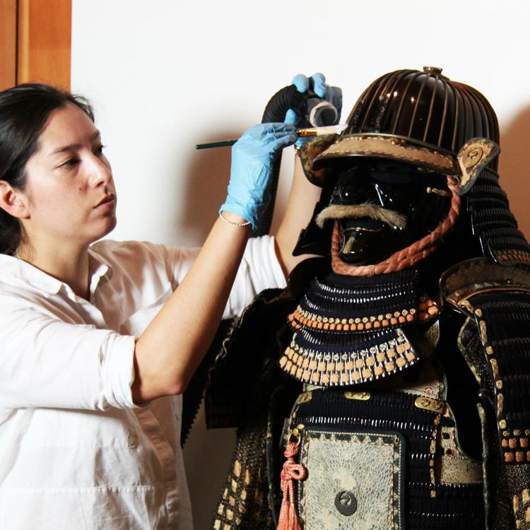 Conservator caring for Samurai armour
