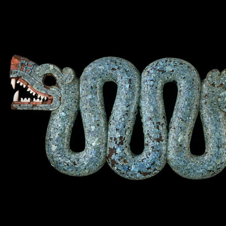 A turquoise two-headed serpent mouth ajar, heads pointing in different directions.
