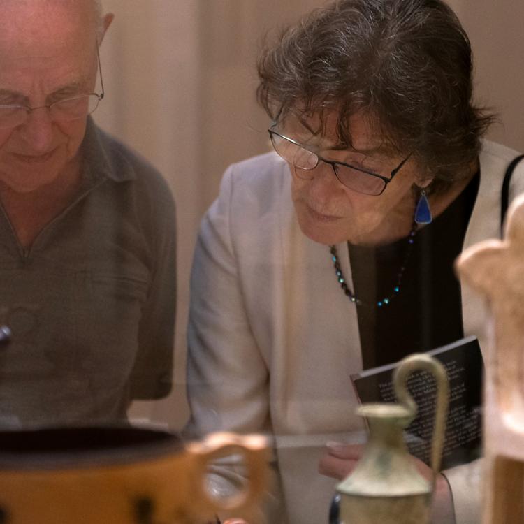 Two visitors inspecting the objects