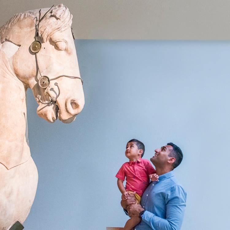 A family looking at a sculpture in the Mausoleum of Halikarnassos