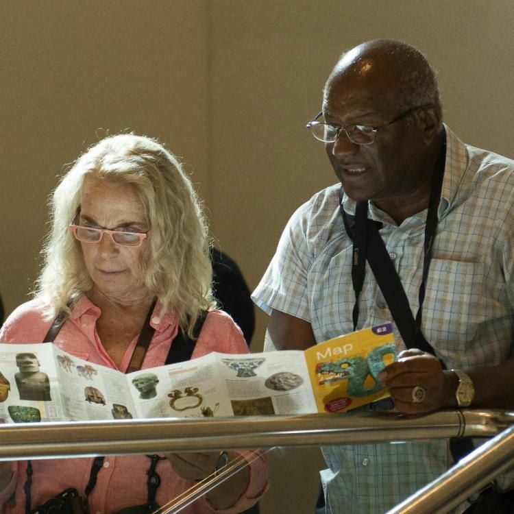 Two visitors looking at a map in the Living and Dying gallery (Room 24) 