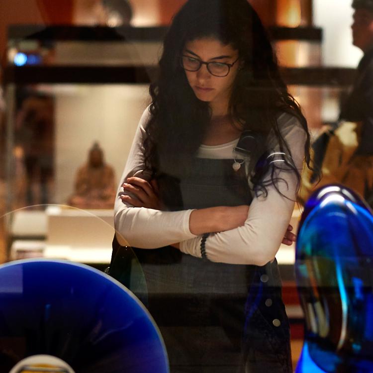 A visitor looking at objects in Room 92