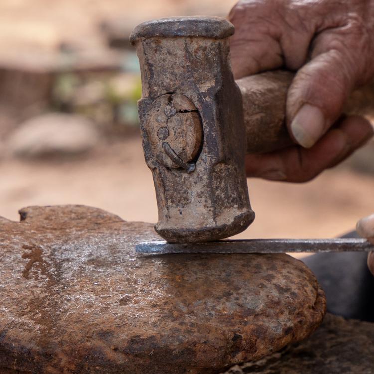 Hammer hitting metal.