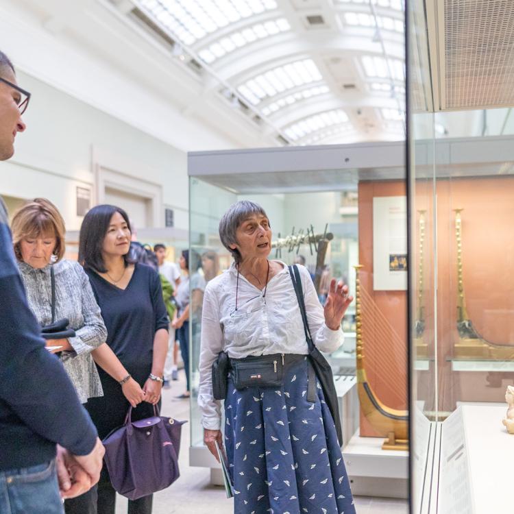 A group looking at sculptures on display in a gallery.