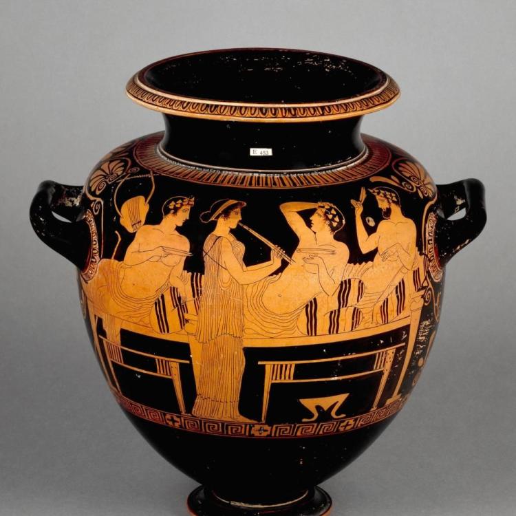  Red-figured stamnos depicting symposion, central standing figure plays a flute, flanked by three reclining figures