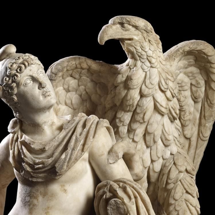 Marble sculpture of Ganymede leaning on tree stump and looking to the eagle which stands on it.
