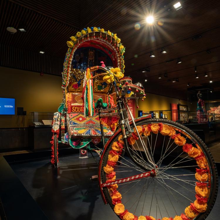 A colourfully decorated cycle rickshaw at the South Asia Gallery at Manchester Museum