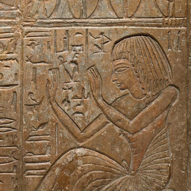 Stela inscribed with hieroglyphs and the picture of a person.