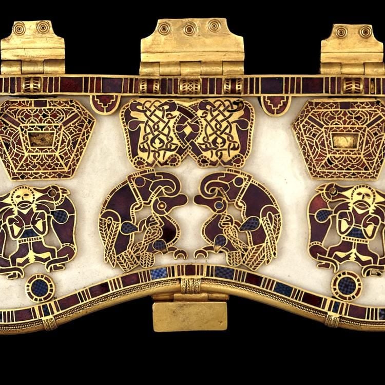 Gold purse lid inlaid with white stone and red gems in intricate geometric patterns.