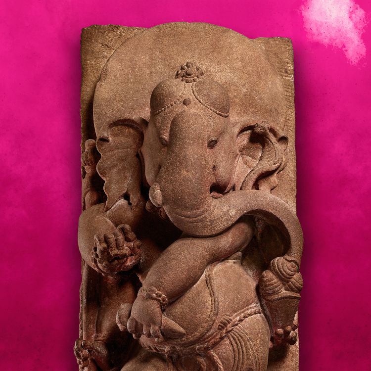 A stone statue of the elephant-headed god Ganesha on a bright pink background