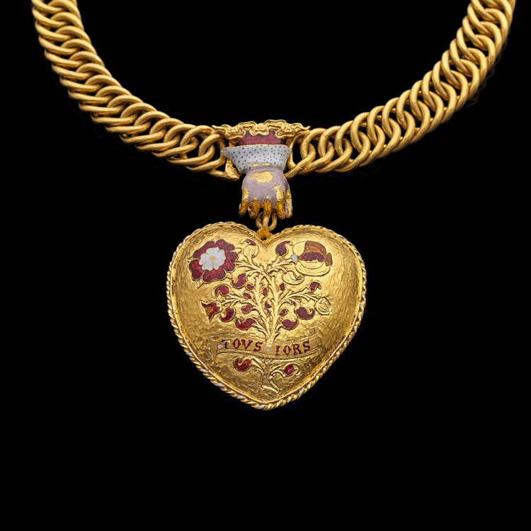 Gold pendant in the shape of a heart with enamelled rose and pomegranate, held on a gold chain by a clasp in the shape of a hand.