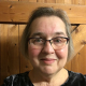 Photograph of Caroline Gonda wearing glasses