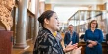 Volunteer talking to visitors in Enlightenment Gallery