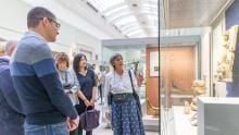 A group looking at sculptures on display in a gallery.