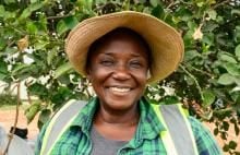 Anna Adamu, sun hat, high-vis, outside, foliage behind
