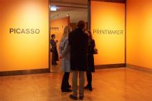 Three patrons stood in the lobby entrance to the 'Picasso: printmaker' exhibition.