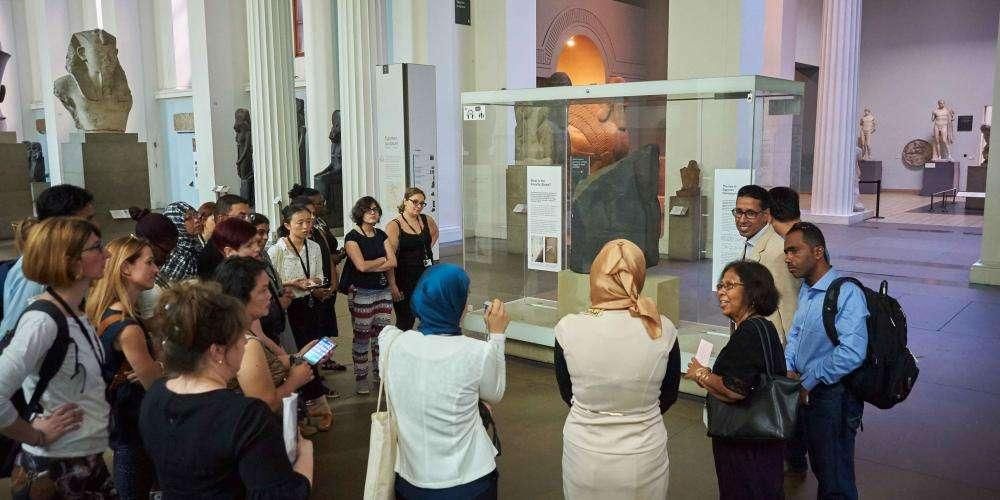 Crowd of visitors around the Rosetta Stone.