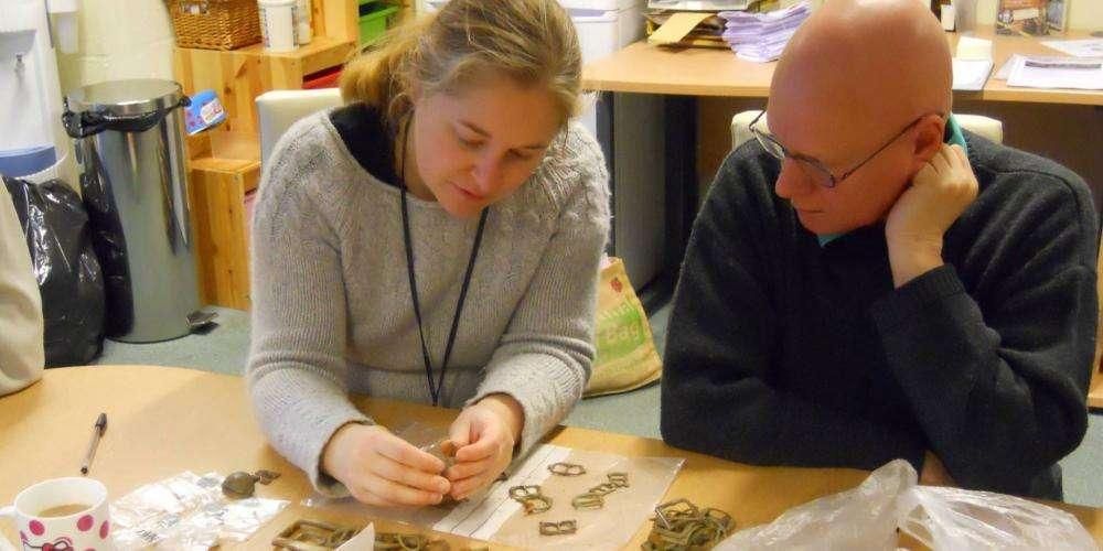 Laura Burnett examining artefacts found at Somerset Flo