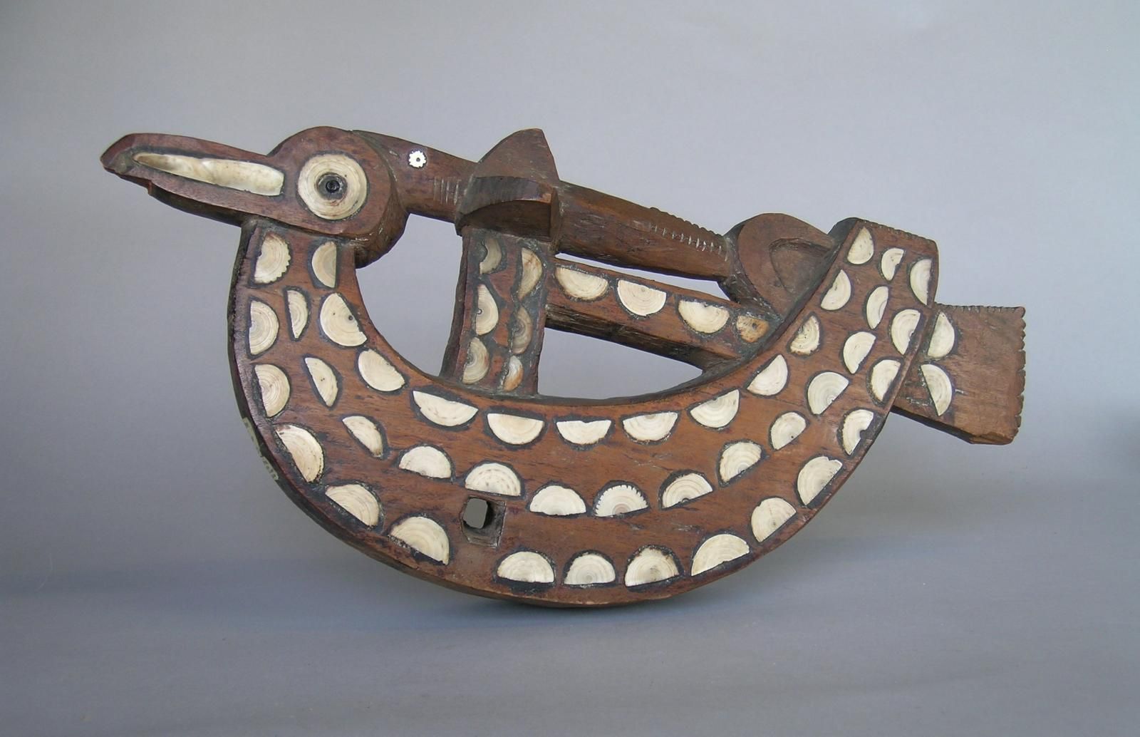 stylised wooden seagull with inlaid shell