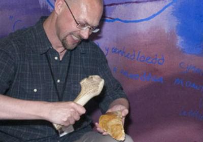 Man holding bone and flint