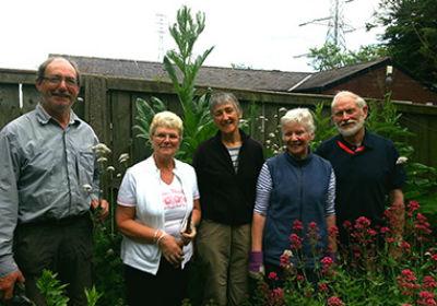 Volunteers standing in herb garden