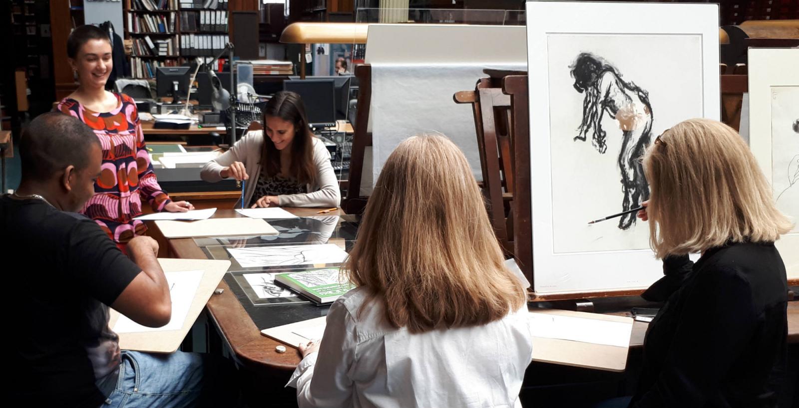 An artist talking to students with sketch pads