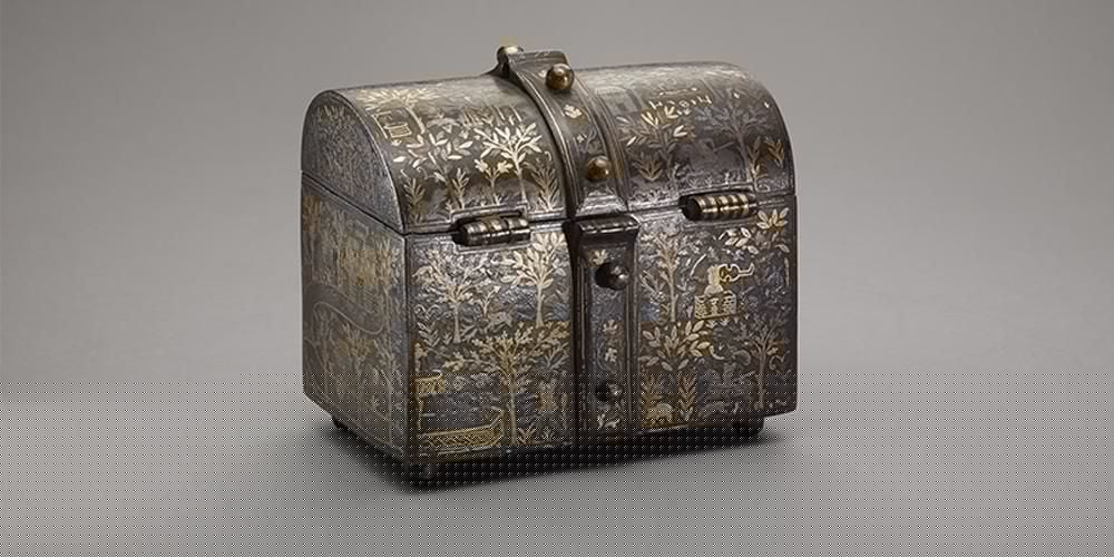 A large iron casket with rounded top.
