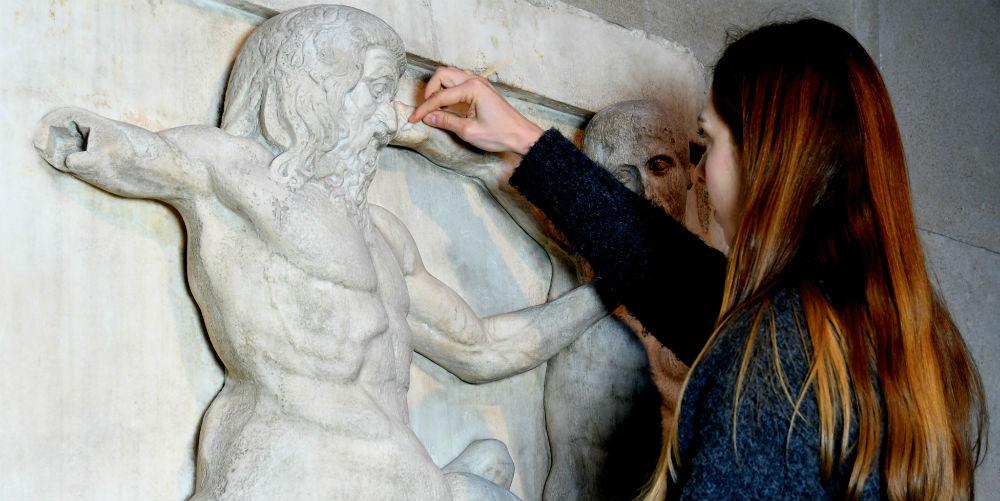 Woman cleaning Parthenon metope