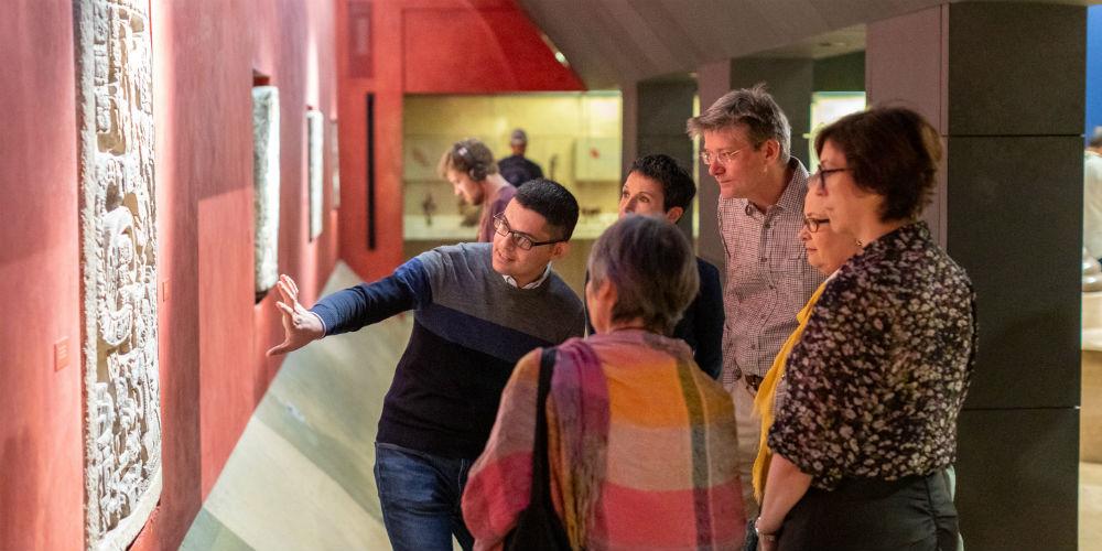 A group of visitors on a guided tour in the Mexico gallery.