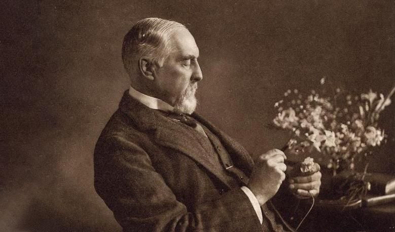 Frederick DuCane Godman sitting in a chair.