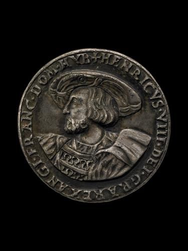 A round silver coin minted in London which depicts Henry VIII 