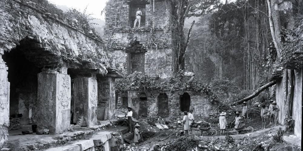 Black and white photograph showing people at ruins in Palenque