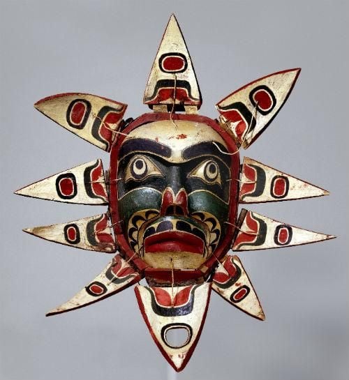 Mask for human, with face and flower like petals around it. 
