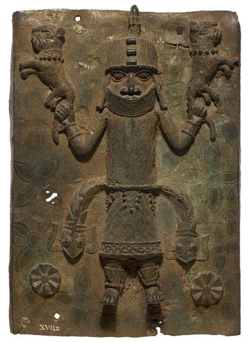 Bronze plaque depicting a royal figure swinging two cats by their tails.
