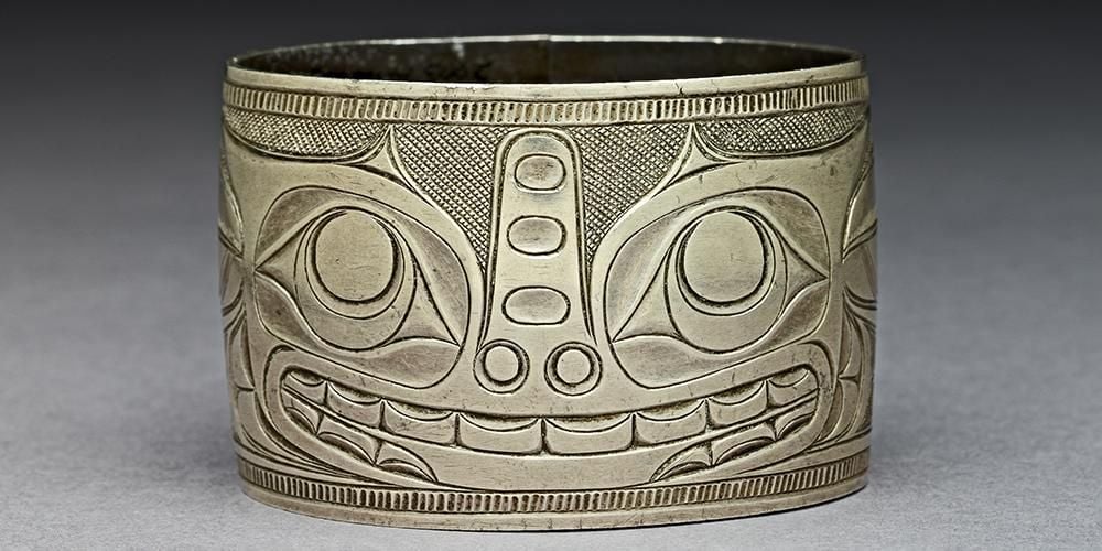 Silver bracelet with engraved design of a sea bear or wasco.