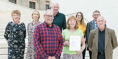 Group of winners with certificate.