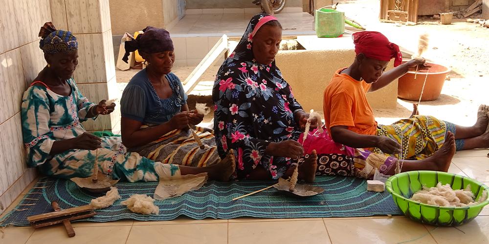 Four women spinning silk.