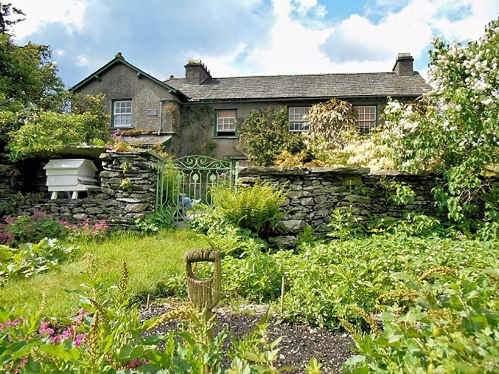 Photograph of a country house taken from the garden.