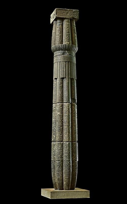 Granodiorite column in the form of a papyrus bundle bearing cartouches of Amenhotep III, Merenptah and Setnakht on abacus, buds and shaft.