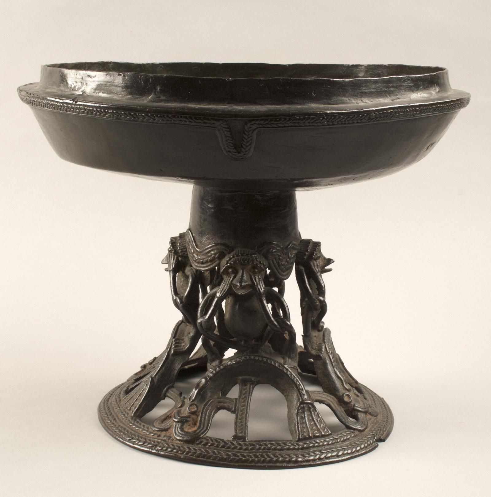 Pedestal bowl sitting atop a pedestal made of an openwork design featuring monkeys and mudfish.