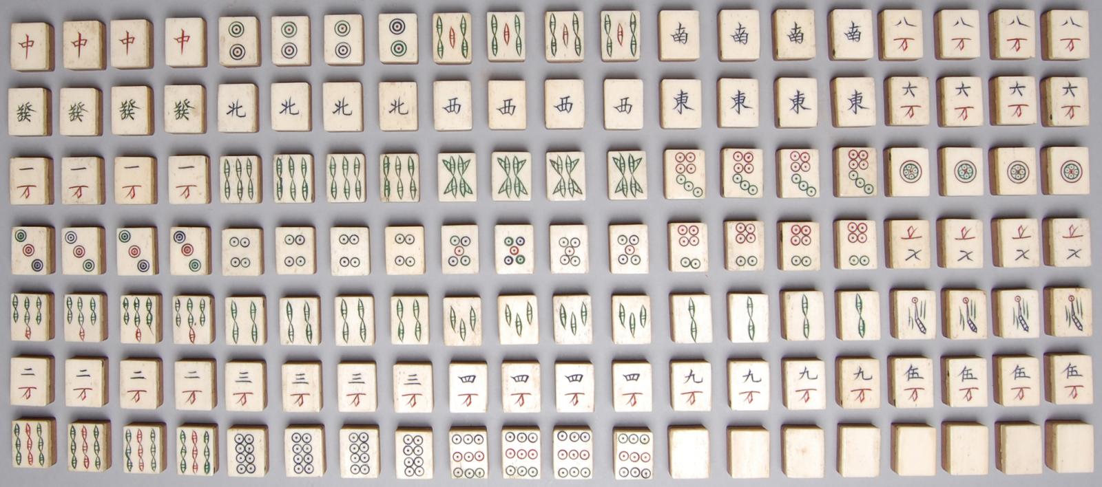 140 tiles in seven rows of 20, most bearing symbols and characters, made of bamboo and bone