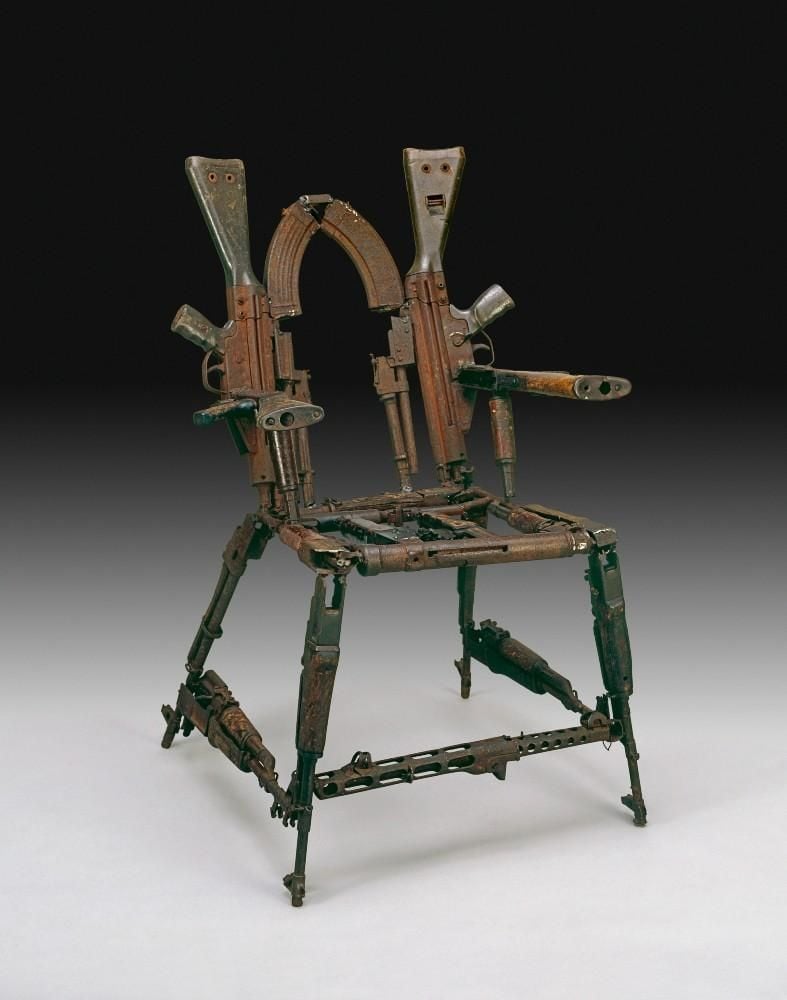 A chair made out of parts of rifles (mainly AK47s) and other weapons welded together.