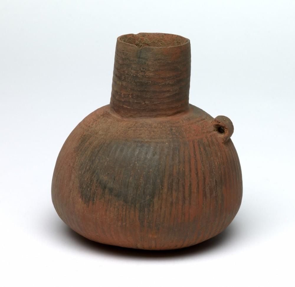 'Red Axumite' jar, medium neck, pierced vertical flat strap handle on shoulder, globular body with decoration