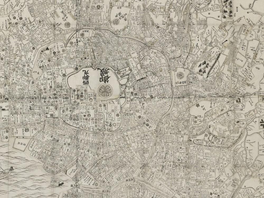 Woodblock print, mounted as hanging scroll. Map of Edo, west at top. At bottom left, list of major places with distances from Nihonbashi.