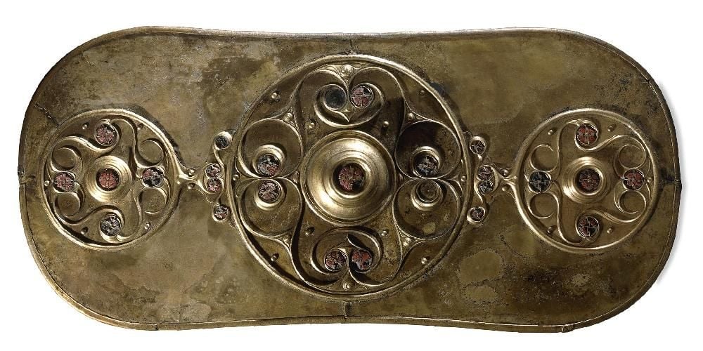 Bronze shield decorated with three circles in relief and 27 red glass studs. 