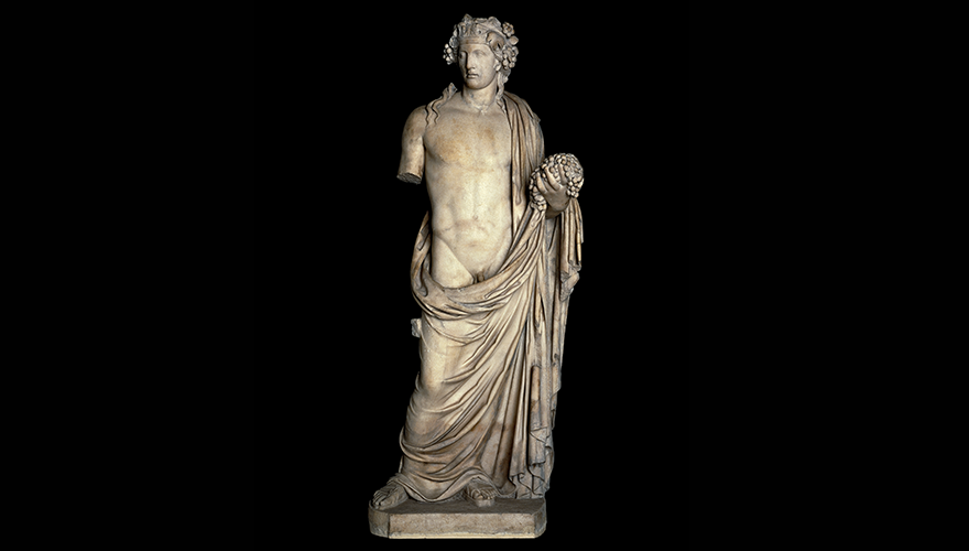 A white marble statue of Dionysos, holding grapes and draped in cloth