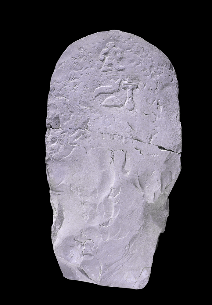 Limestone stela showing a figure with dwarfism at the top