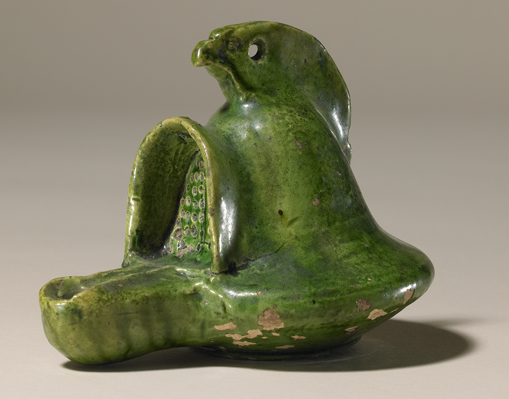Lamp in the form of a gladiator helmet glazed in a deep green colour