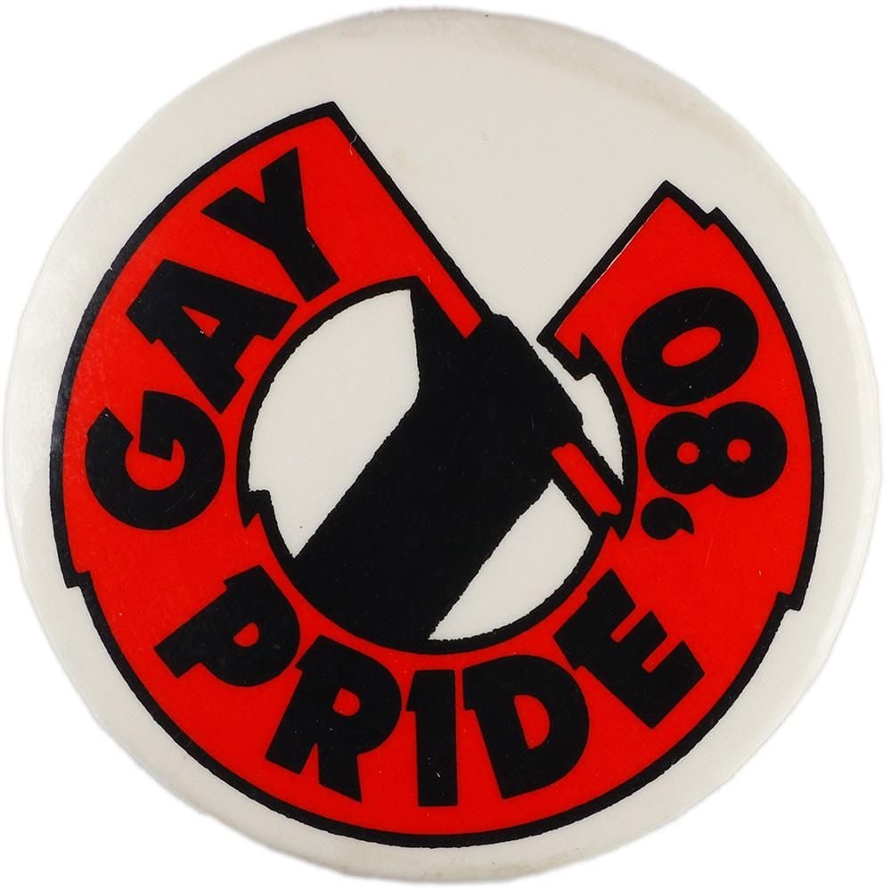 Badge of an arm with a hand holding a red banner that swirls around the circle of the badge and bears the words: GAY PRIDE '80