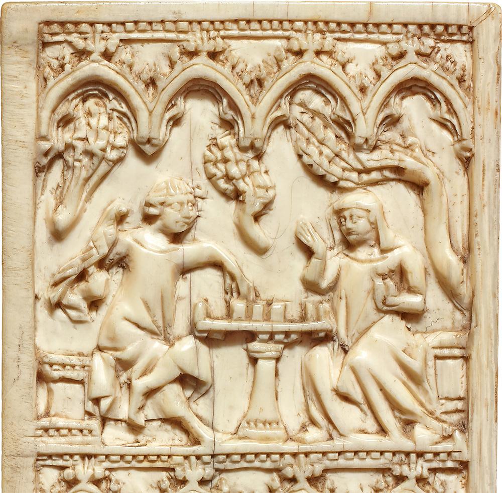 Writing tablet with scene of a man and woman playing chess under vines and arches